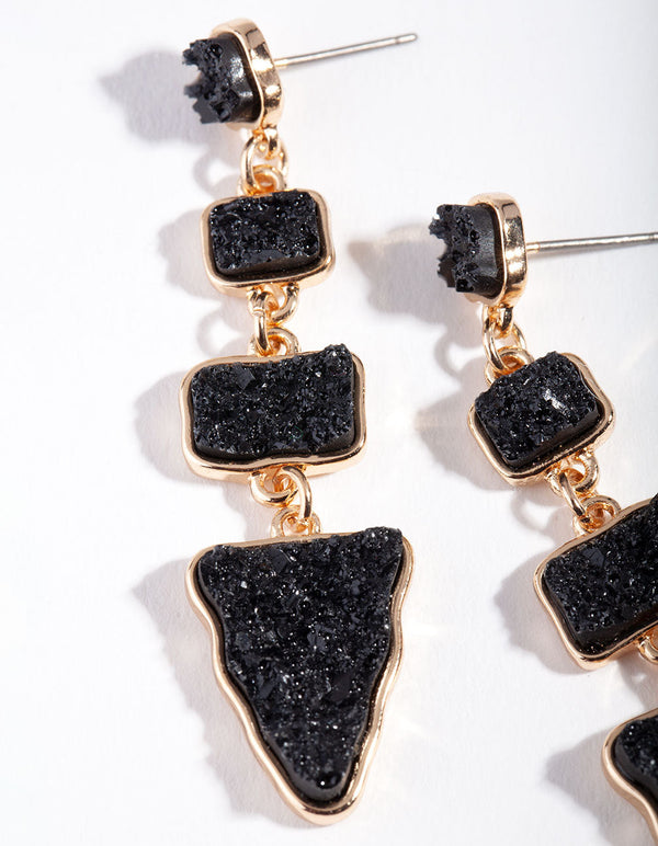 Złote, czarne, teksturowane kolczyki z geometrycznymi kamieniami