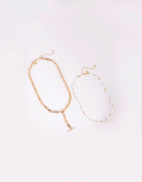 Gouden en witte parelketting - link has visual effect only